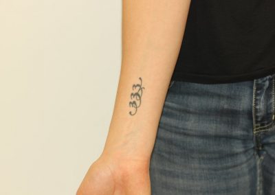 Black numbers wrist tattoo before laser tattoo removal
