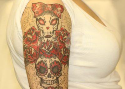 Colourful half sleeve tattoo before treatment