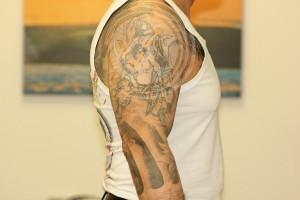 Large black sleeve tattoo 6 months after 1 treatment